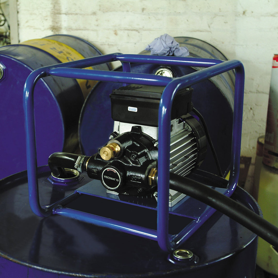 Viscomat Self Priming Rotary Pump- location shot, pump in frame with hoses attached transferring oil from barrel