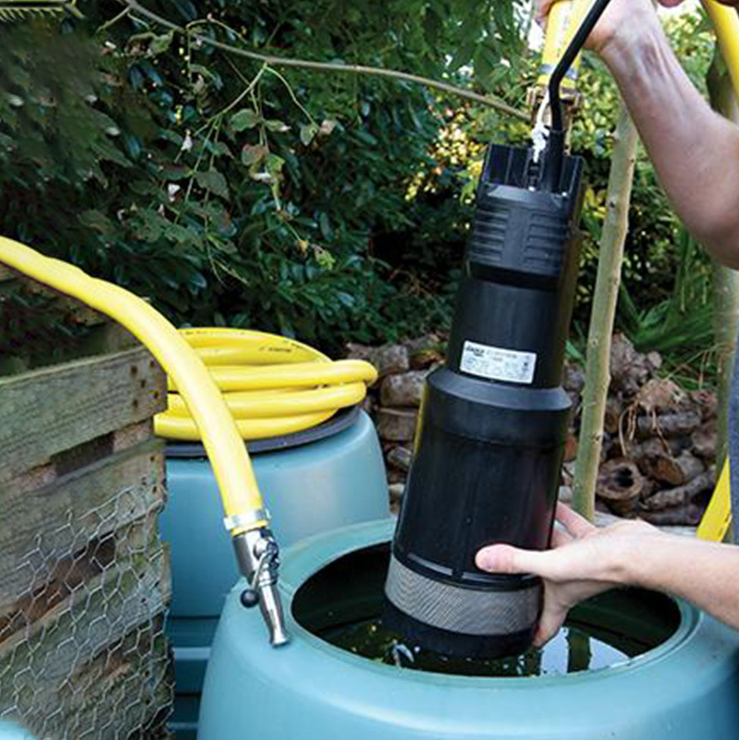 Divertron Submersible Irrigation Water Pump- location shot, Divertron with hose attachment being placed into a rainwater tank