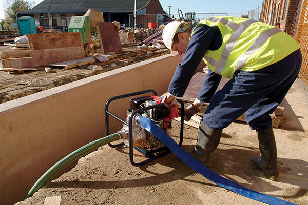 TE-YD Centrifugal Diesel Pump - location shot, man preparing pump for underground extraction with hose attachment