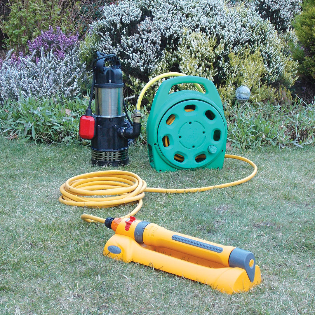 MVH-10A Submersible Irrigation Pump- location shot, pump set up in garden ready to be used attached to hose and sprinkler